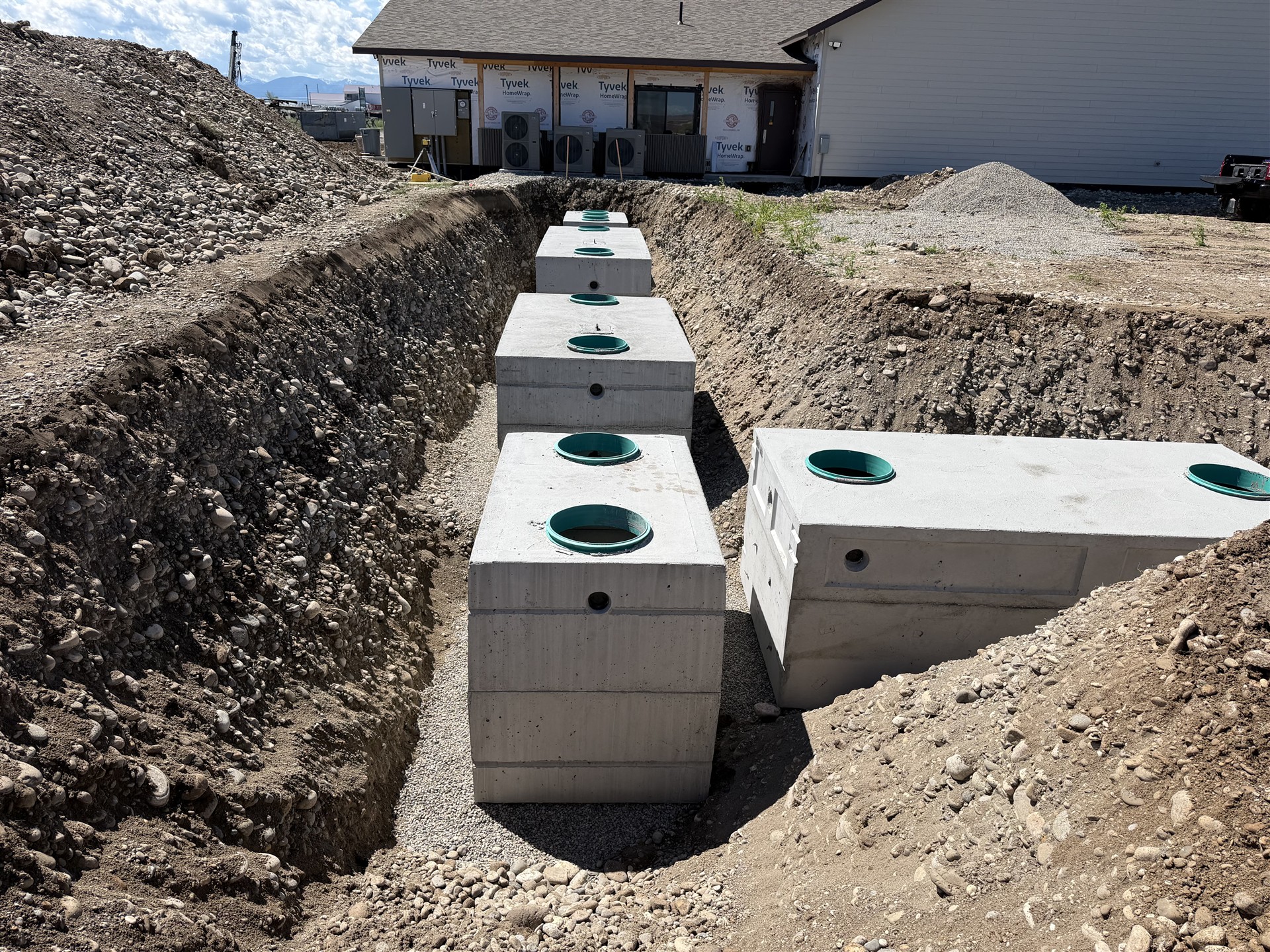 Multiple septic tanks set in an excavated installation area