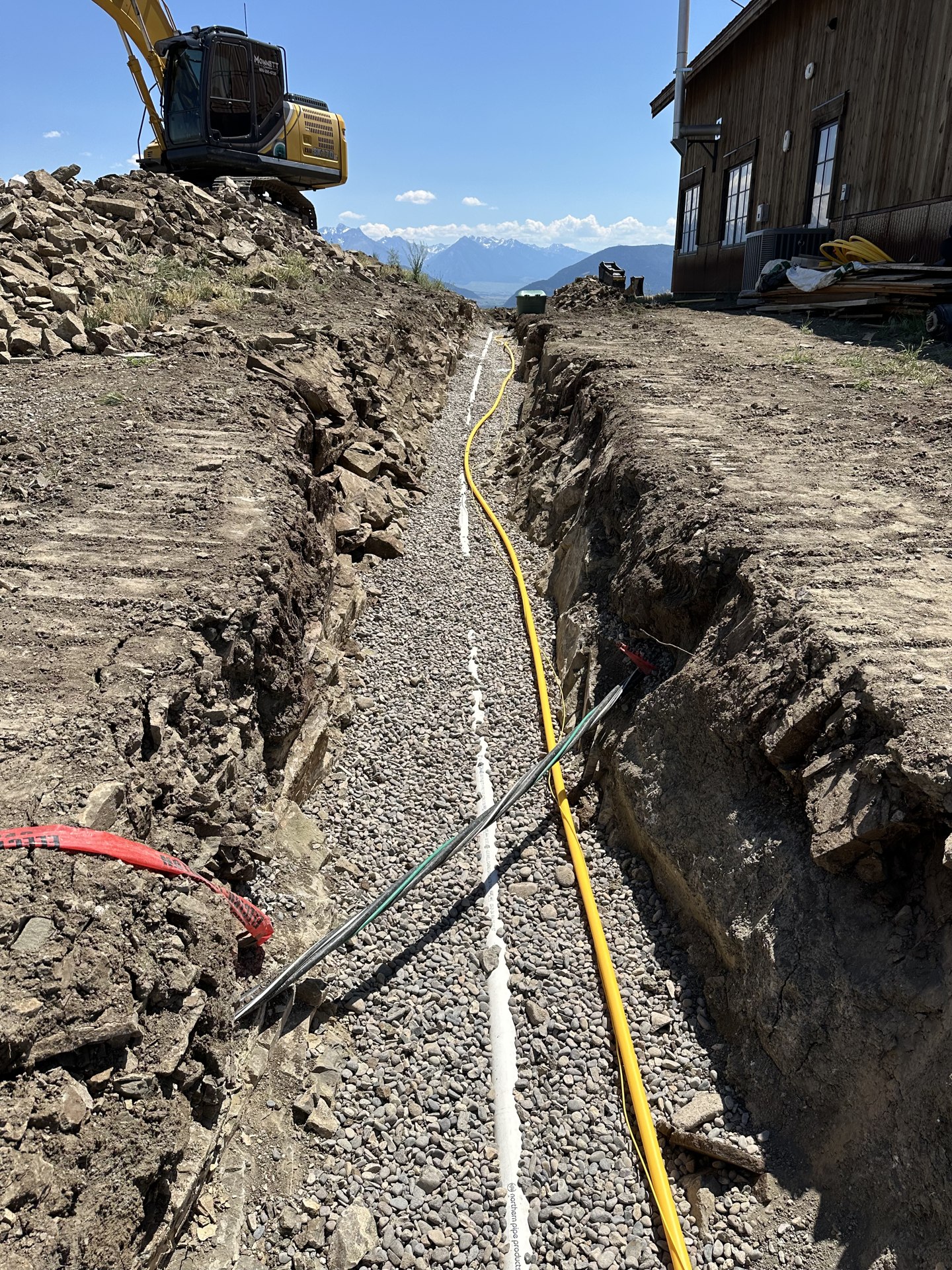 Underground utility lines laid in a gravel-bedded trench