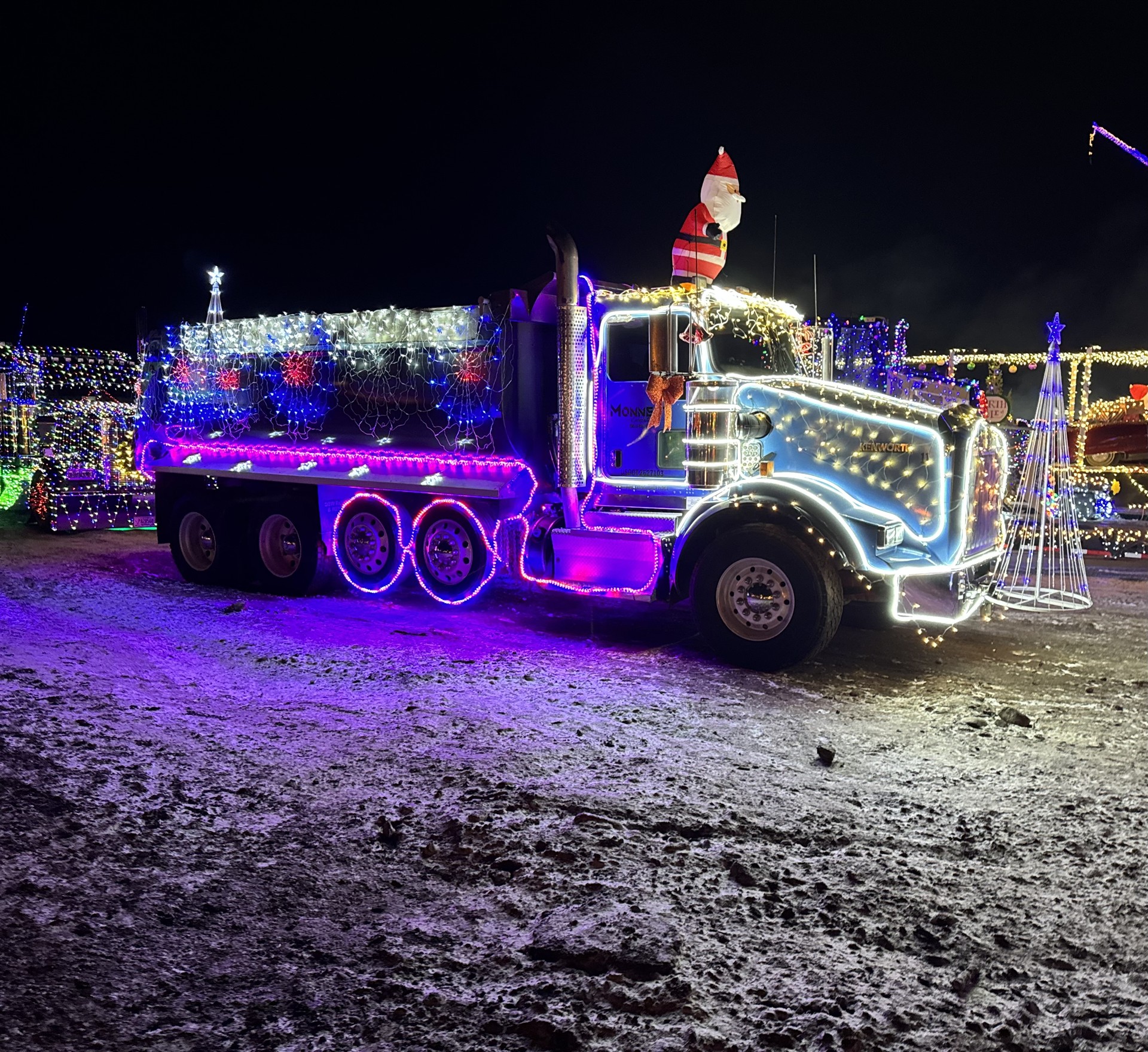 Monnett gravel truck decorated with colorful Christmas lights