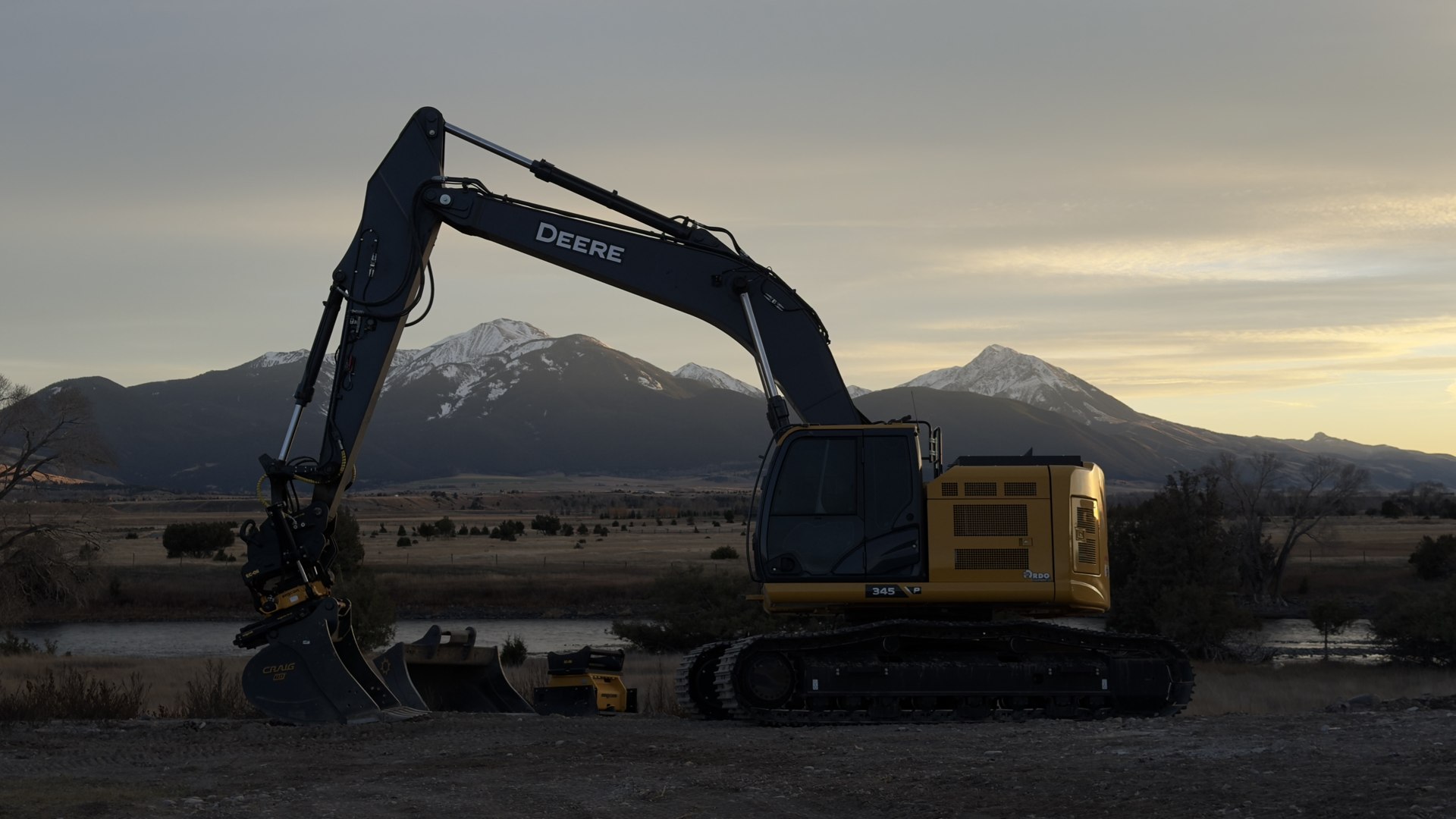 Monnett excavator framed by Montana mountains at sunset