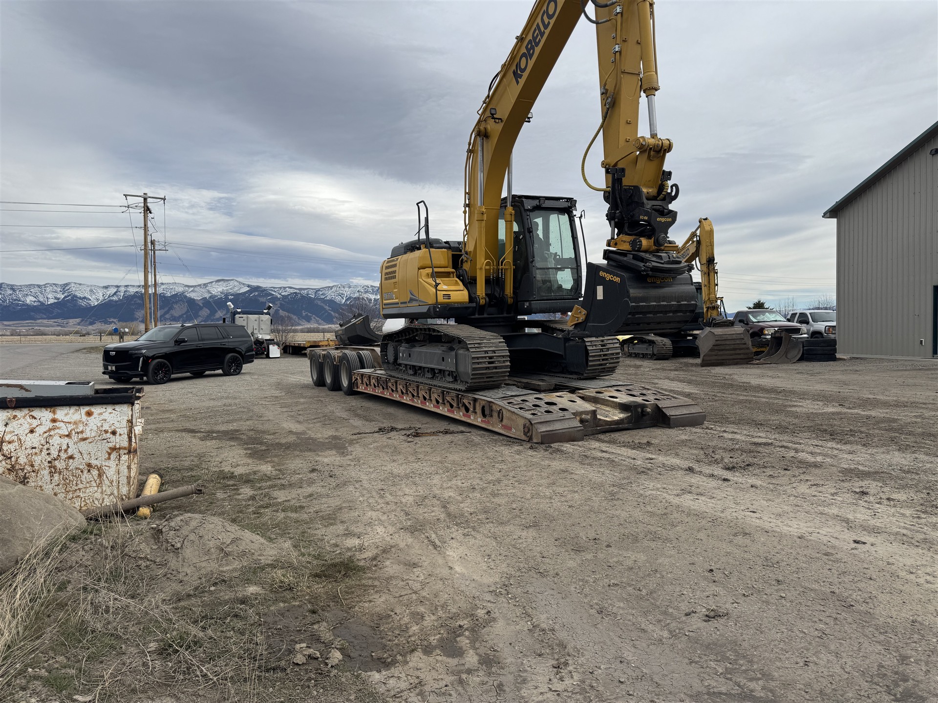 Monnett excavator loaded on an equipment trailer